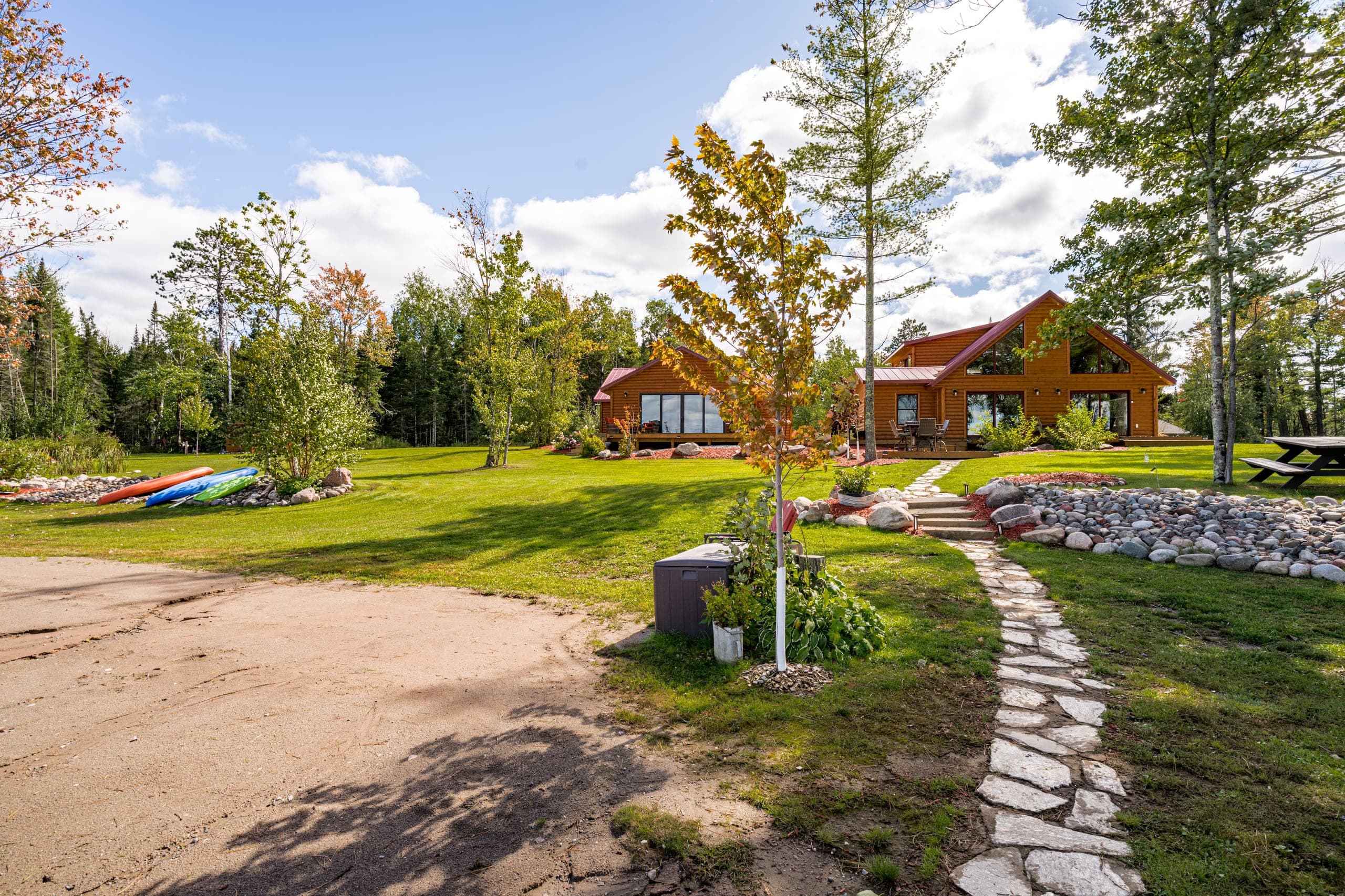 Lawn, kayaks, and the cabin from the shoreline