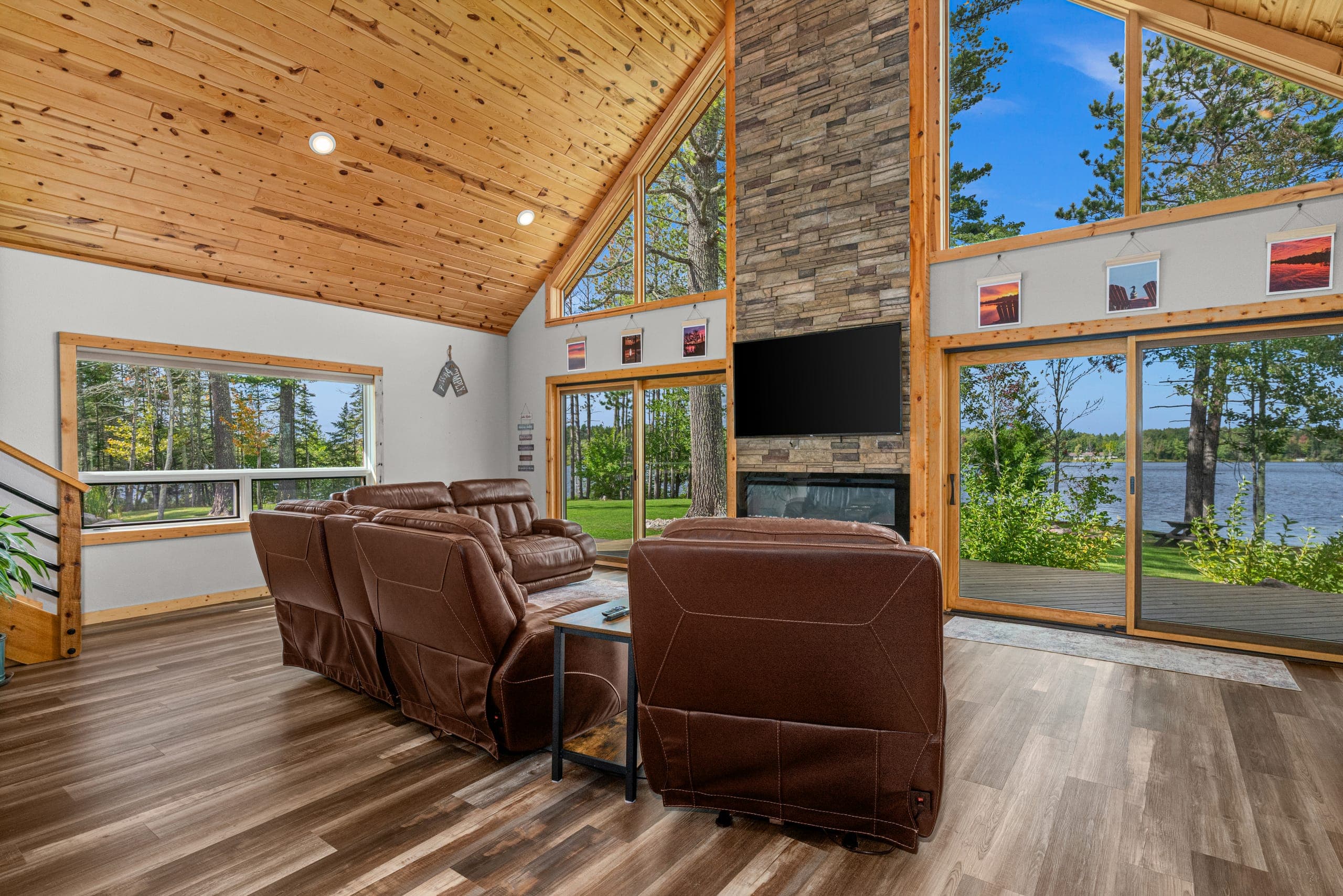 Leather chairs facing the fireplace and the lake