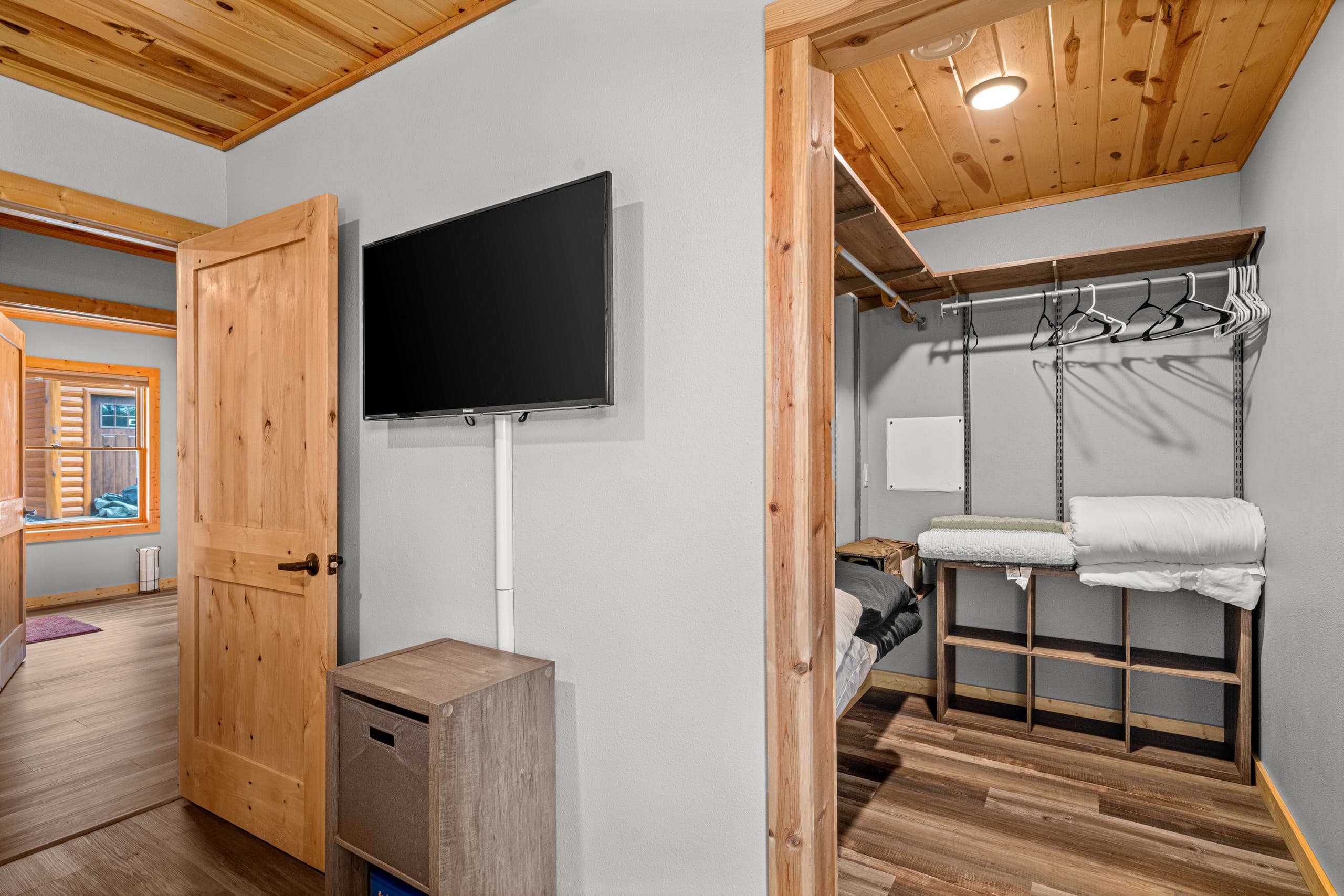 Bunk room with a television and open closet