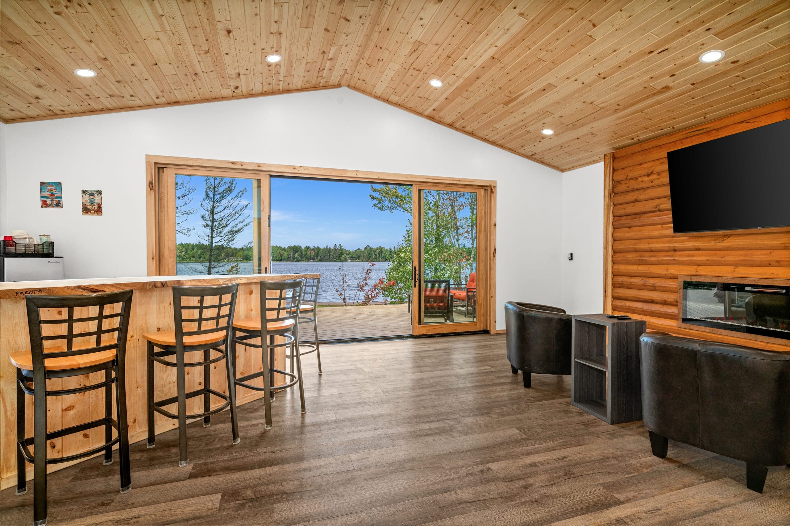 Bar stools facing sliding doors to the lake