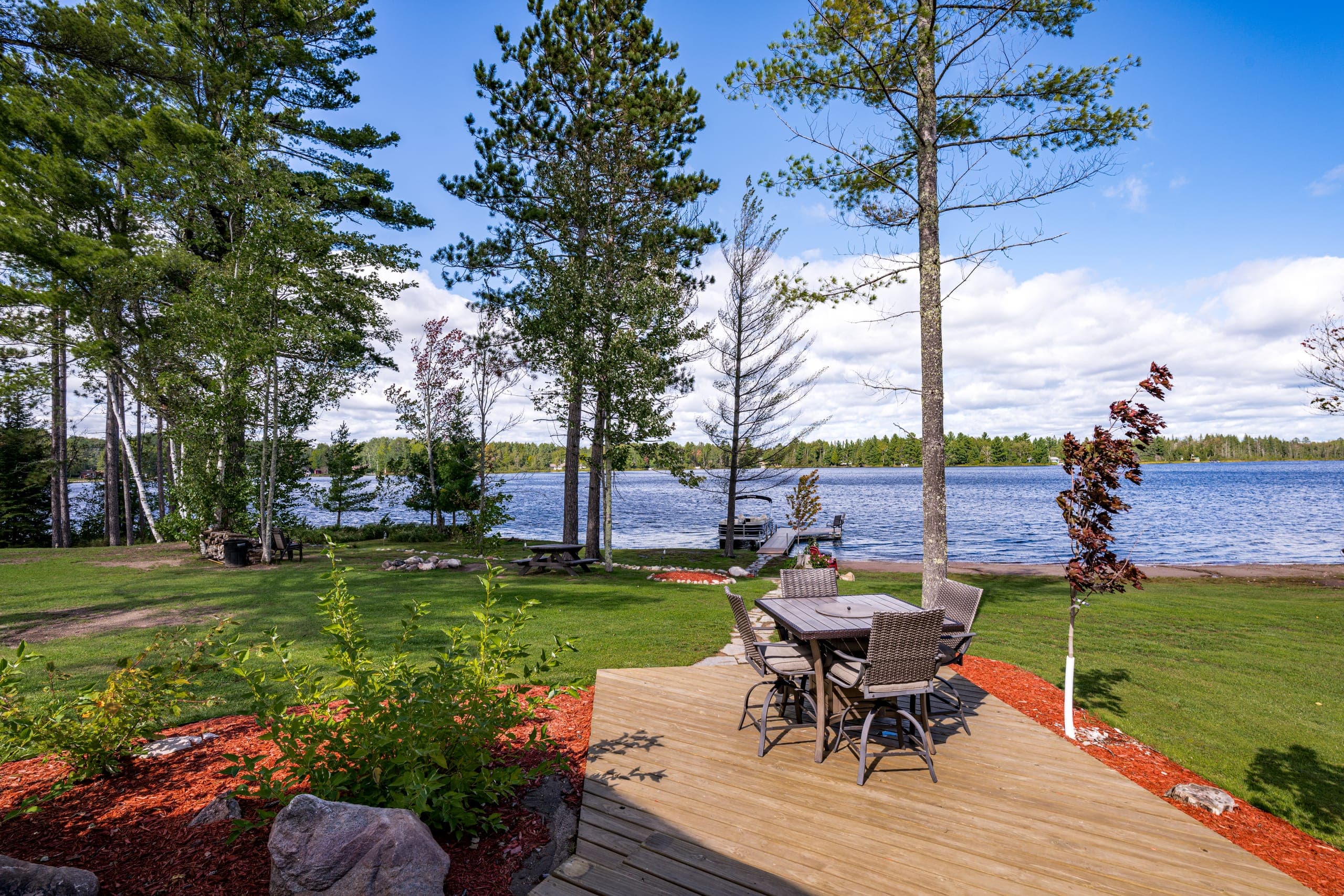 Outdoor dining table on the deck by the water