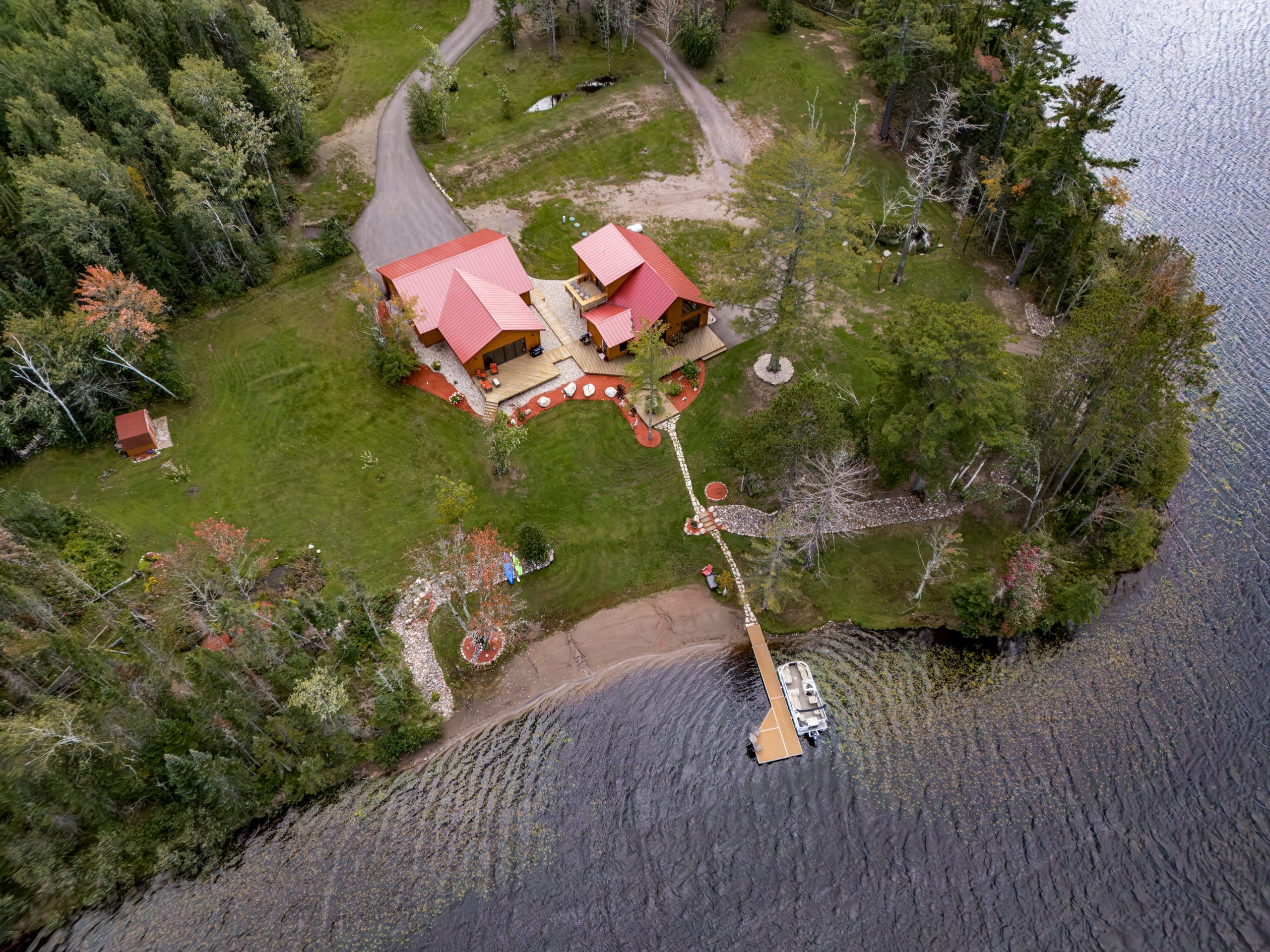 Overhead view of the cabin, lawn, and shoreline