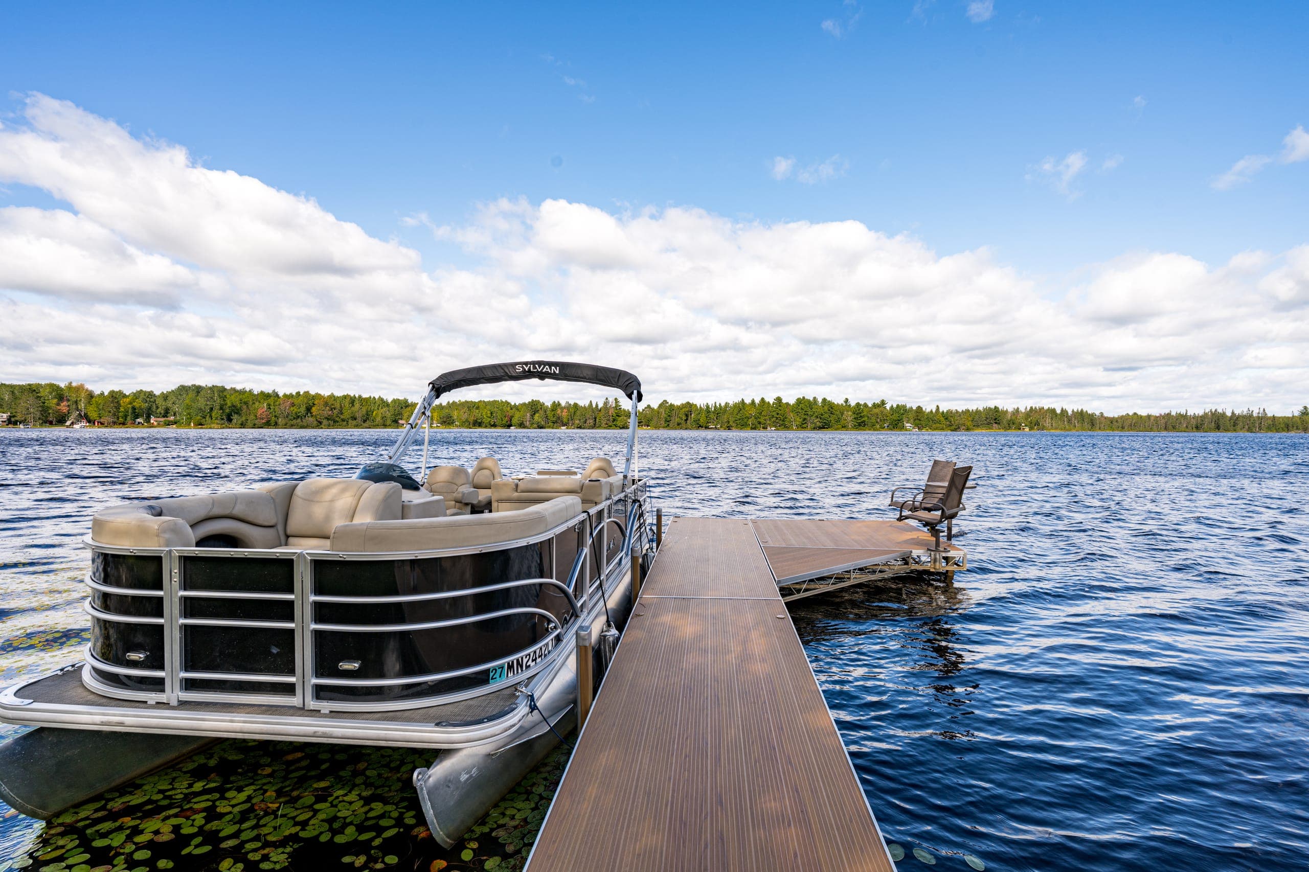 Pontoon boat alongside the dock
