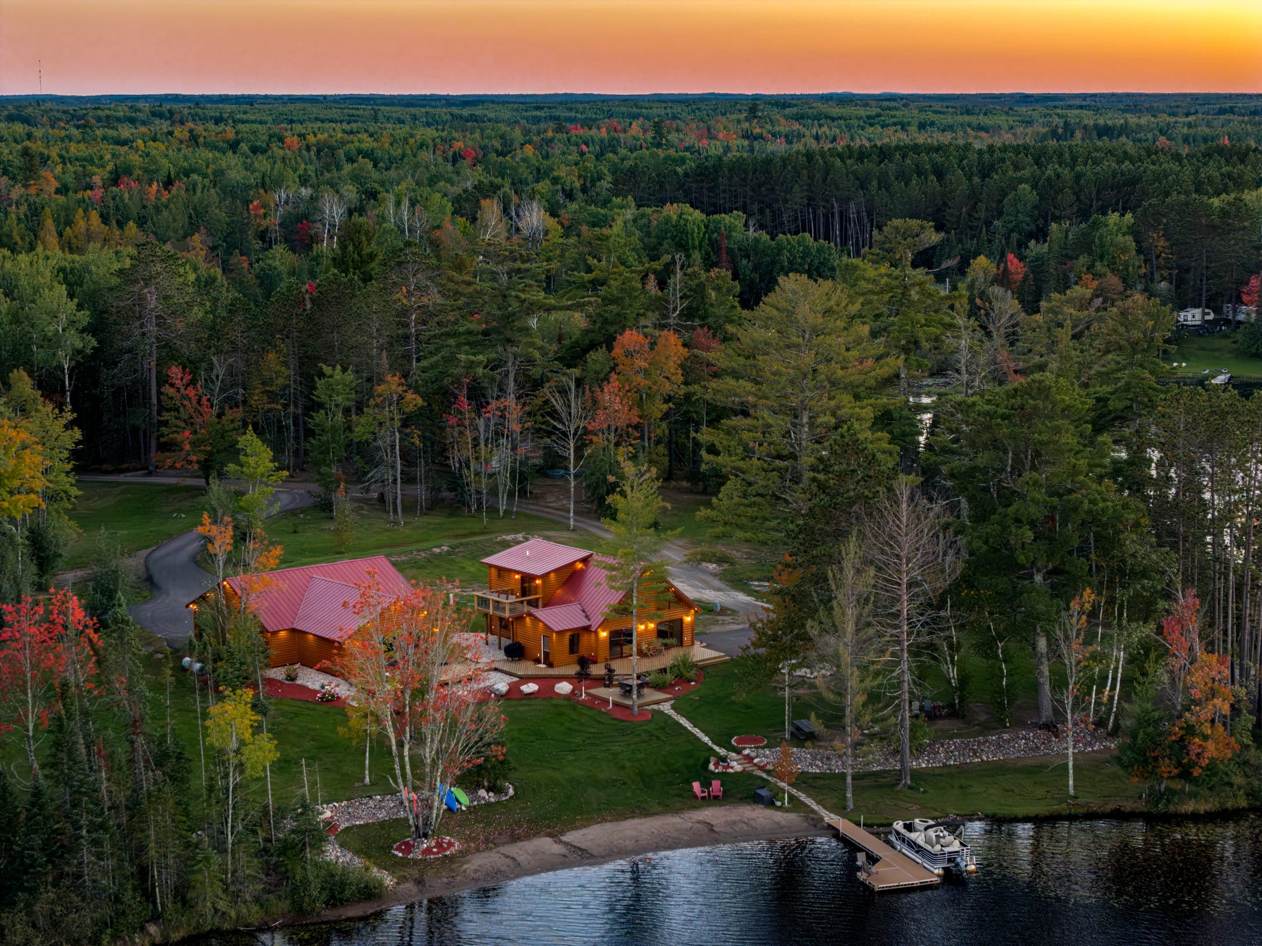 Aerial of the cabins and dock with the sunset on the horizon