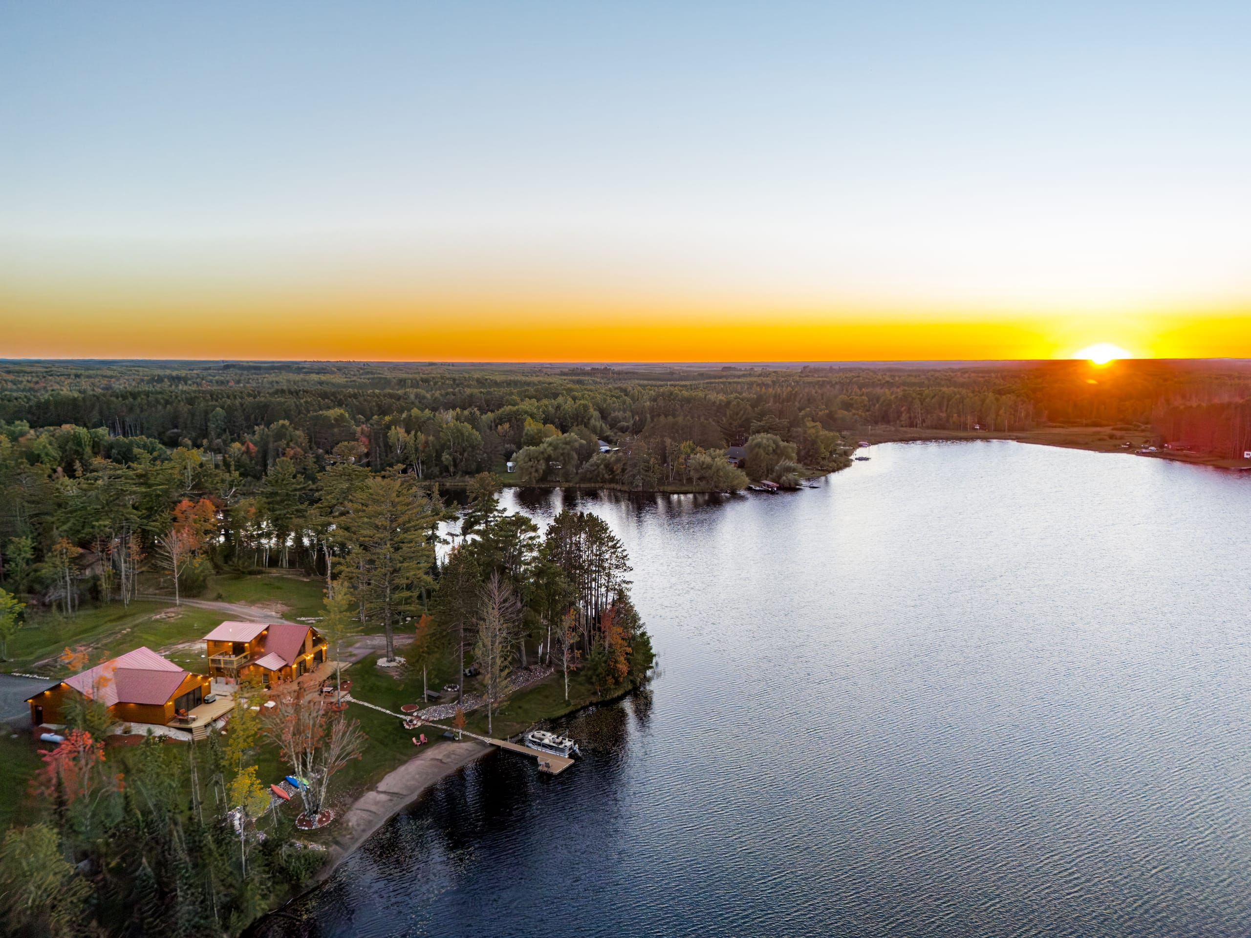Sunset over the lake, with the cabin on the point